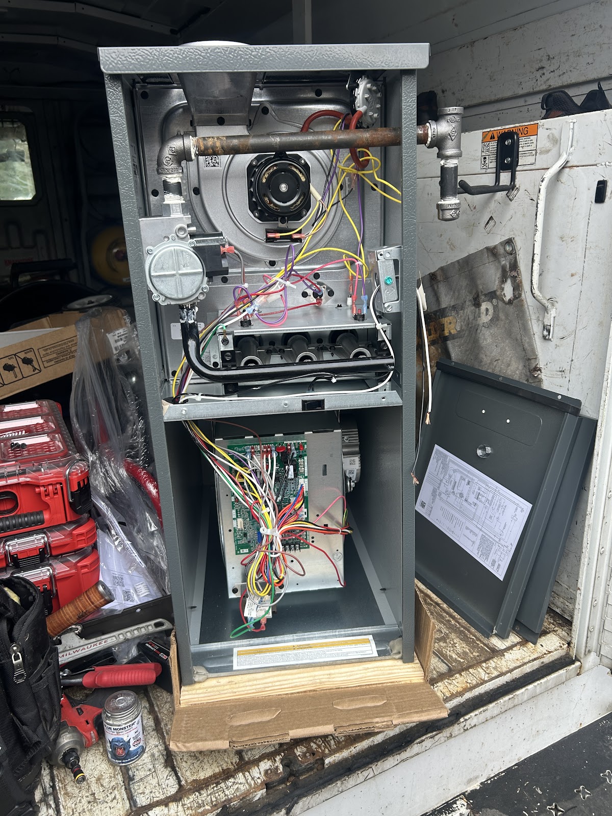 A furnace opened up for service in the work van
