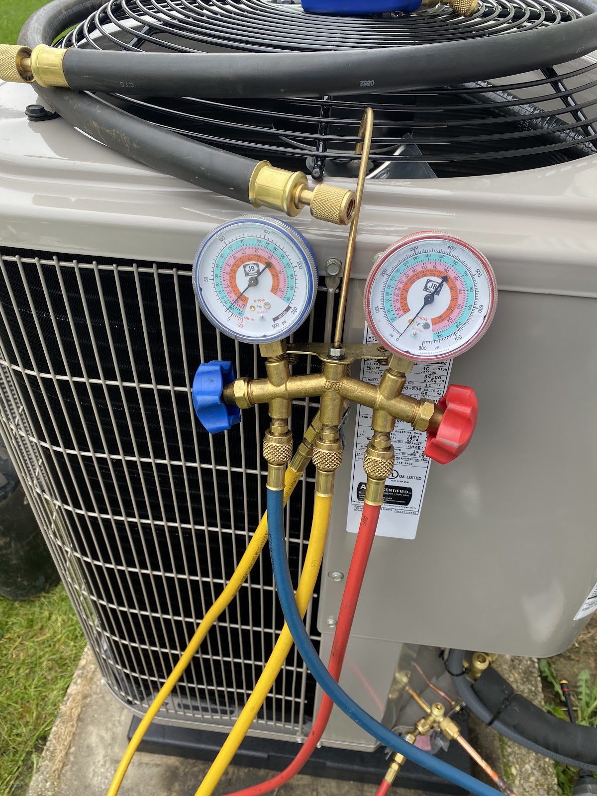 Gauges hooked up to an AC unit during a tune up